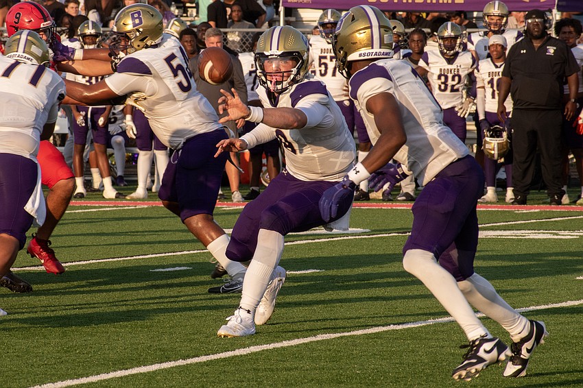 Booker High's Ryan Downes pitches the ball to Dylan Wester.