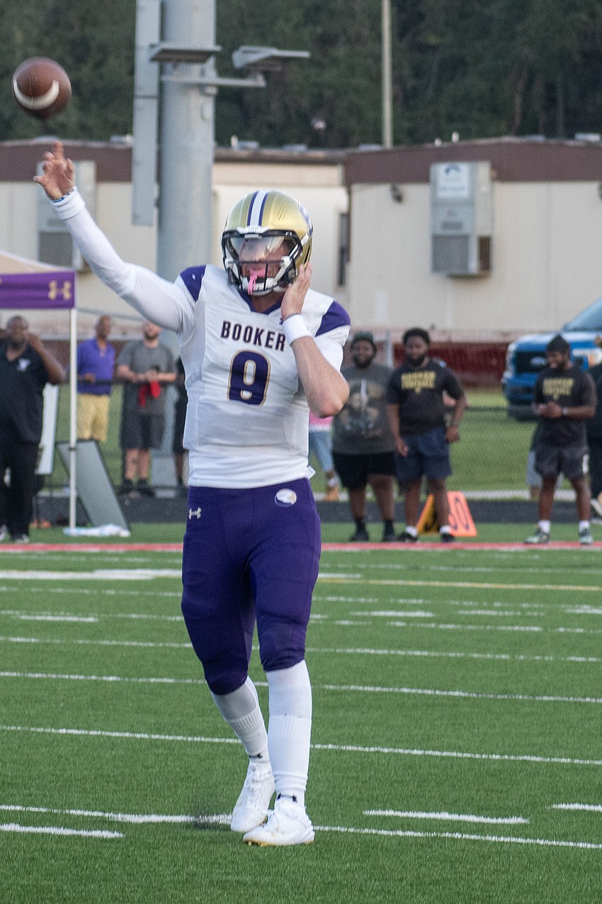 Booker High's Ryan Downes launches a pass downfield against Cardinal Mooney High.