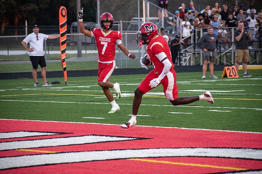 Cardinal Mooney High's Bo O'Daniel (7) celebrates as teammate Marcus Galloway jogs into the end zone for a touchdown.