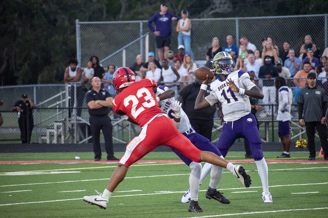 Booker High junior quarterback Joel Morris launches a pass to junior Dylan Wester for a touchdown against Cardinal Mooney High in a preseason clash. Morris threw three touchdowns against Lely High on Aug. 23.