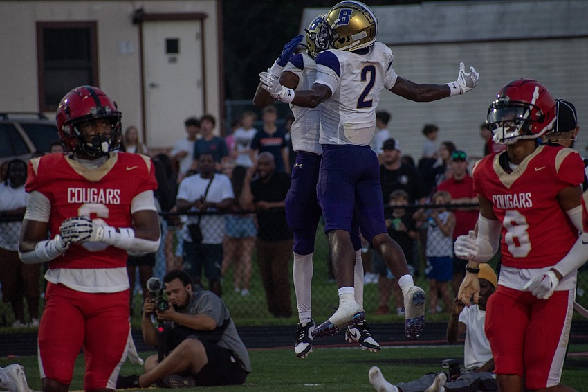 Booker High junior receivers Dylan Wester and Tyren Wortham (2) chest bump after a Wester touchdown against Cardinal Mooney High.