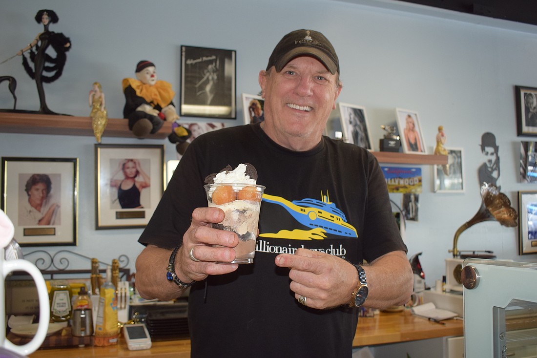 Gary Hagen makes donut sundaes at the new Donuts By Design.