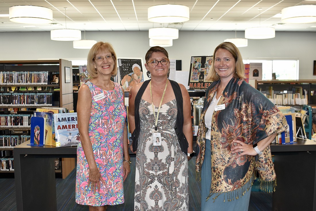 President Sue Ann Miller, librarian Tiffany Mautino and board member Janet Allen attend the ceremony to celebrate the Robinson Family Foundation's book donation.