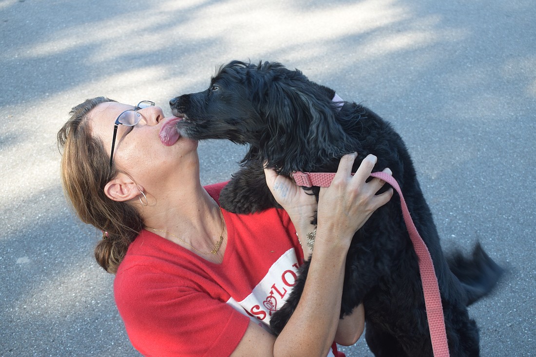 Summerfield's Maureen Flaherty receives kisses from Mina, who recognized "Auntie Mo" within five seconds of seeing her. It's been at least two years since Flaherty last saw Mina.