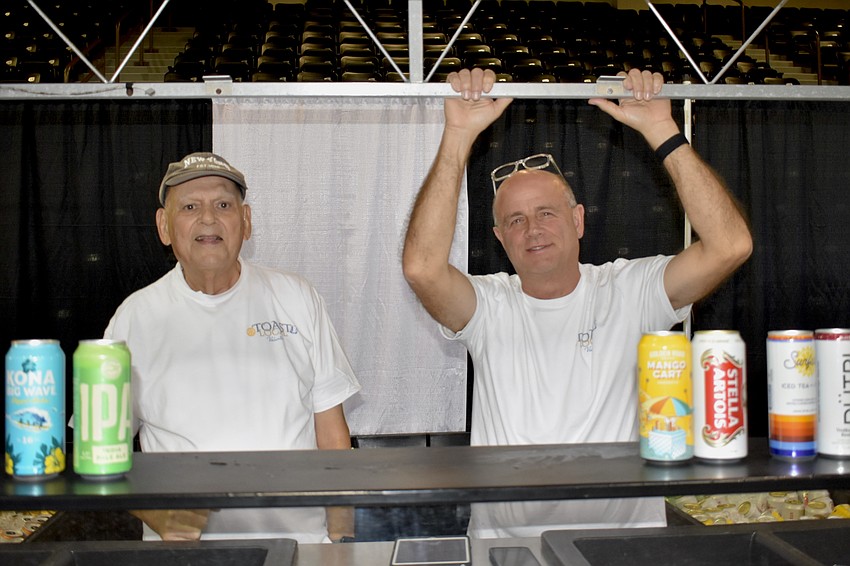 Volunteers Nick Rossi and Michael Nestor serve behind the counter.