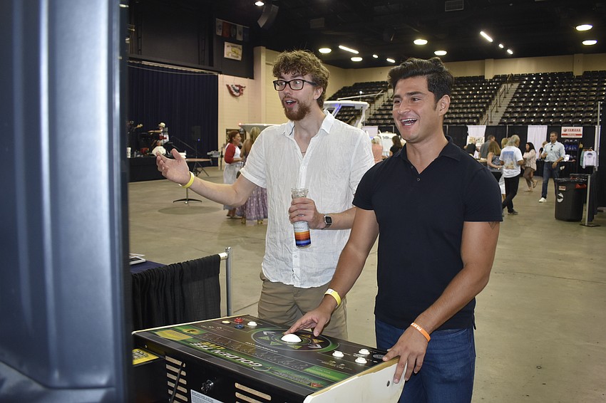 Nick Benson and David Rico try their hand at a golf video game.