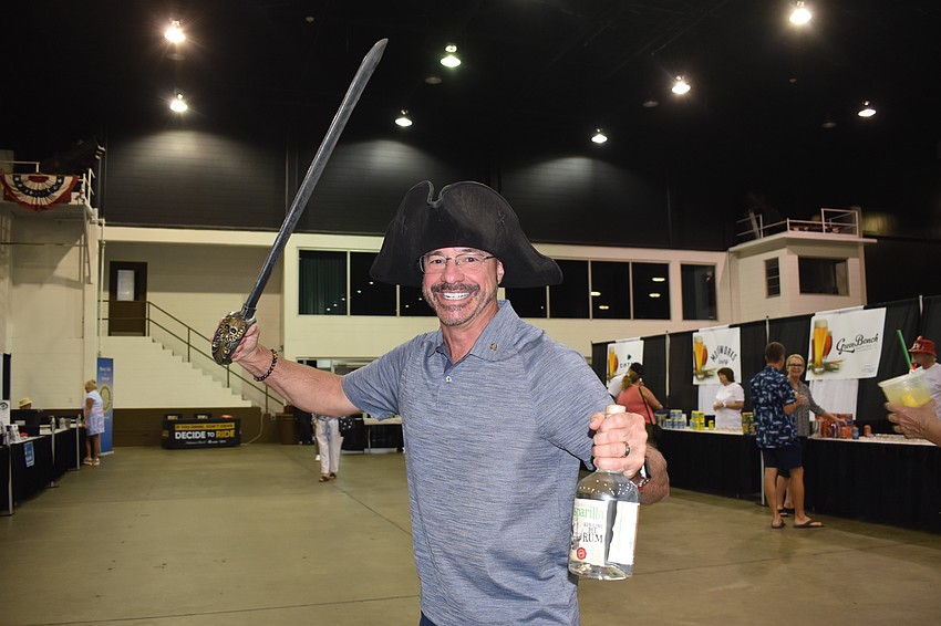 Chris Fehr, a board member of the Lakewood Ranch Rotary Club, came out to support the Sarasota club and also tried on the gear at Gasparilla Rum.