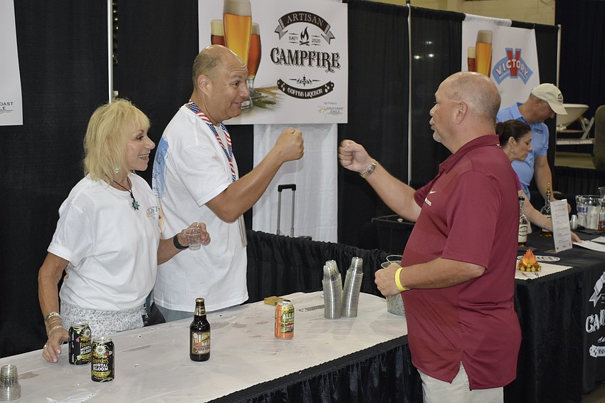Shurri Harris and Brett Magiet greet Scott Pettine.
