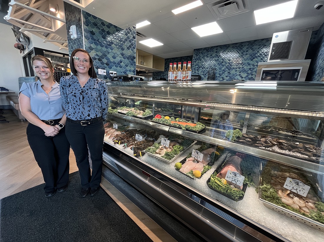 Deep Lagoon Seafood & Oyster House general manager Leslie Carmody and division manager Dacie Broshears show the variety of seafood available in the restaurant's fresh food market.