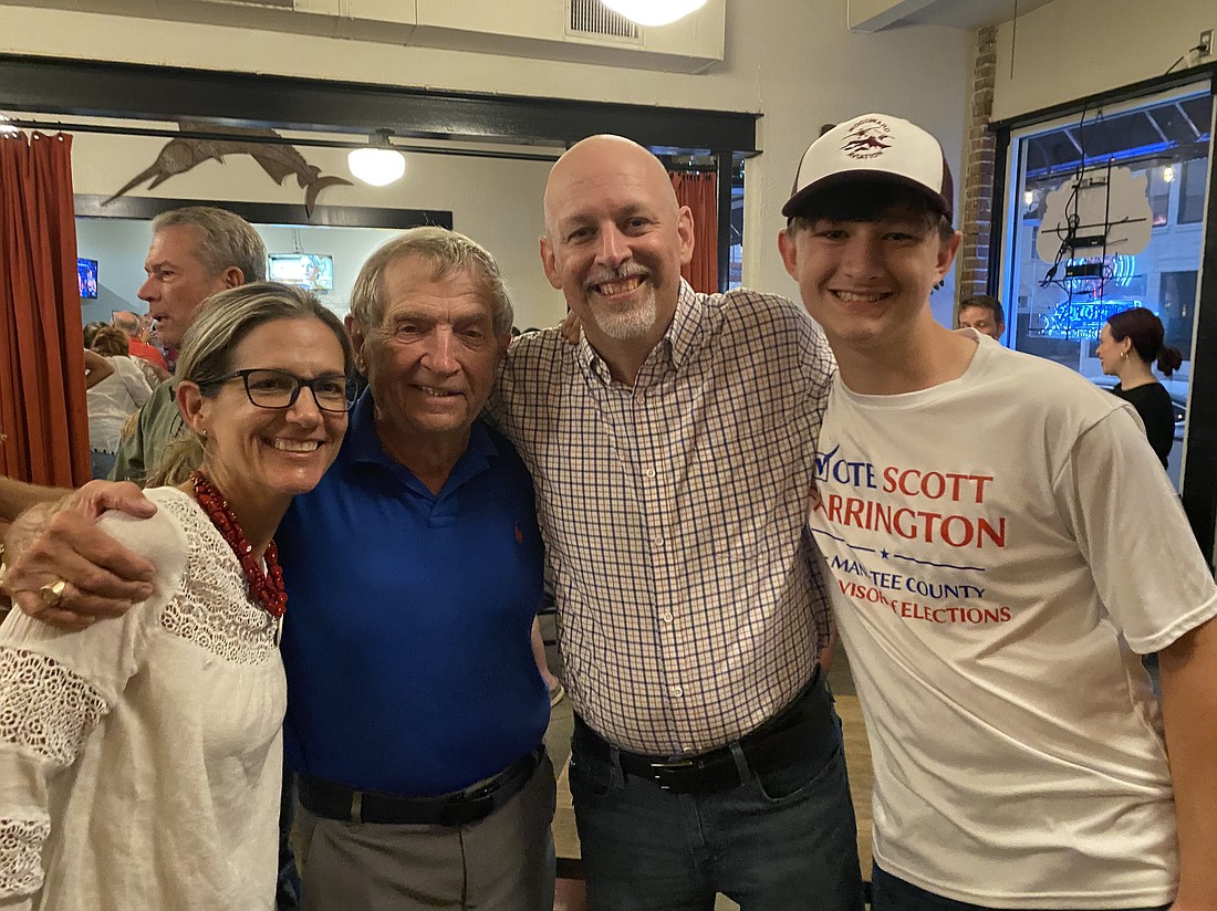 Amy Farrington, Mike Bennett, Scott Farrington and Jacob Farrington celebrate Scott Farrington's win for the republican nominee of the supervisor of elections. He will face write-in candidate Thomas Dell in the general election.