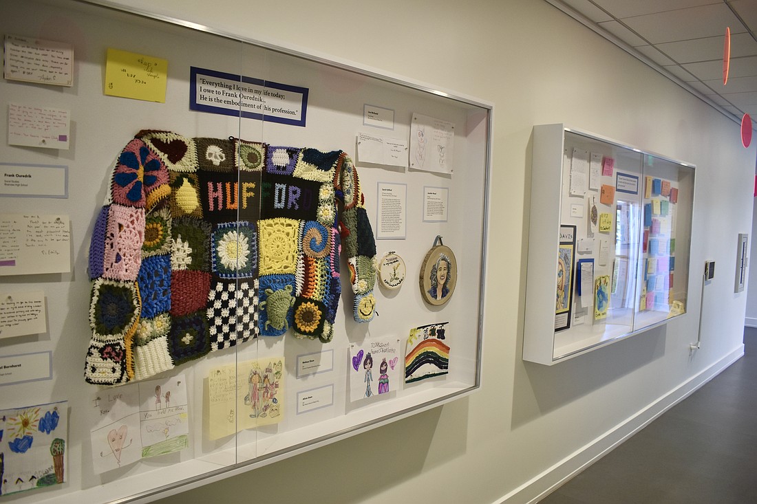 Artifacts in the exhibit include a cardigan created for Riverview High School teacher Sarah Hufford.