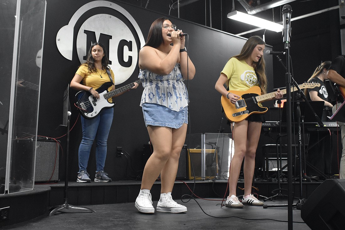 Silvanna Escobar, 17, Jersey Baldini, 15 and Harper Weyant, 15 of The Heartbreakers, perform on stage.