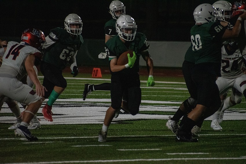 Lakewood Ranch High junior Colton Dempsey bursts through the Lemon Bay High defense.