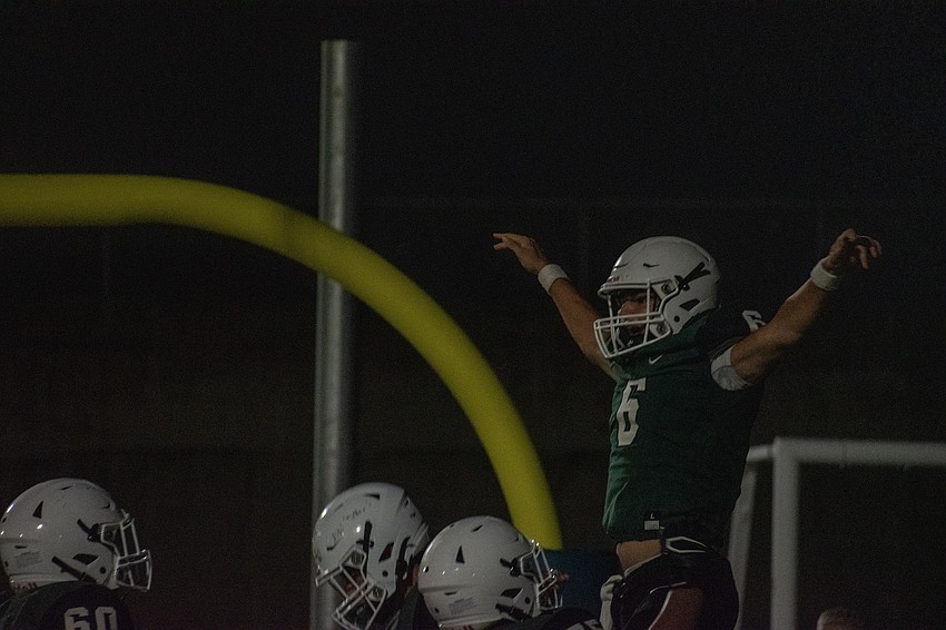 Lakewood Ranch High quarterback Liam Fernandez is lifted by his teammates after a touchdown run against Lemon Bay High.