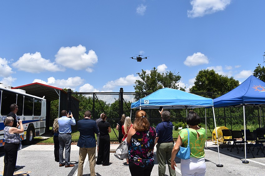 Phones are pointed to the air as the drone takes off for a demonstration. The drone has not been deployed yet, but is intended to assist on calls for drug overdoses, wounds and cardiac arrests.