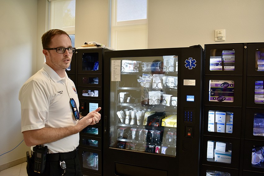 Sean Dwyer, assistant chief of special operations for Manatee County's Emergency Medical Services, shows alliance members vending machines in the Malachite Drive EMS station that are stocked with medical supplies.