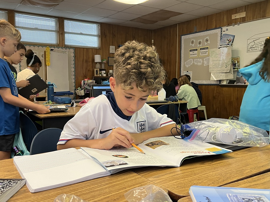 Maddox Gaulman, a B.D. Gullett Elementary School third grader, underlines important lines in a reading passage.