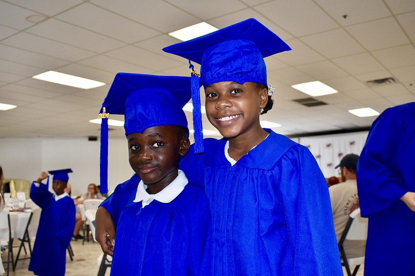 Kwaku Addae, 7 and Joy Prophete, 8, prepare for graduation.