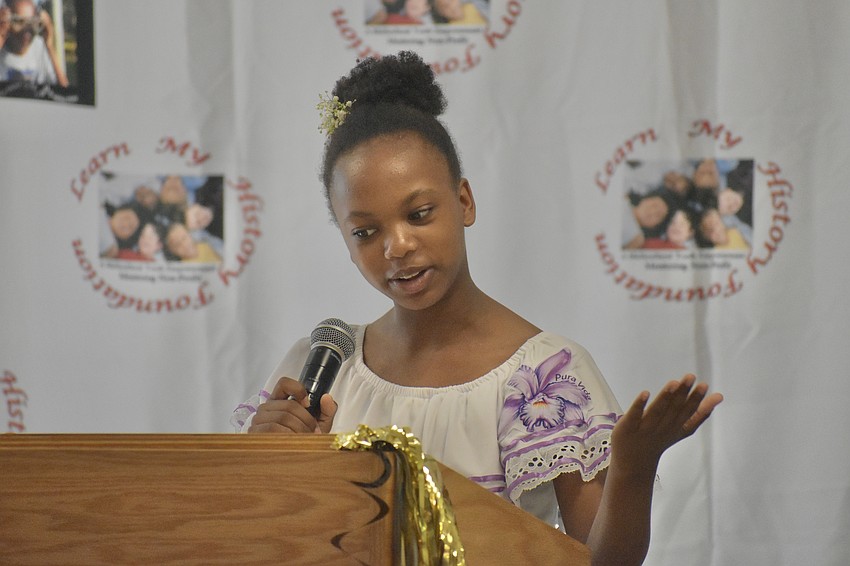 Grace Prophete, who at age 14, serves as Hawkins' manager, takes to the podium. 