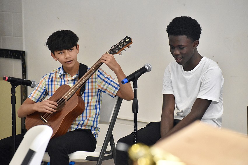 Zenmar Cerdenio-Santiago, 13, and Kofi Addae, 13 offer a performance before the graduation.