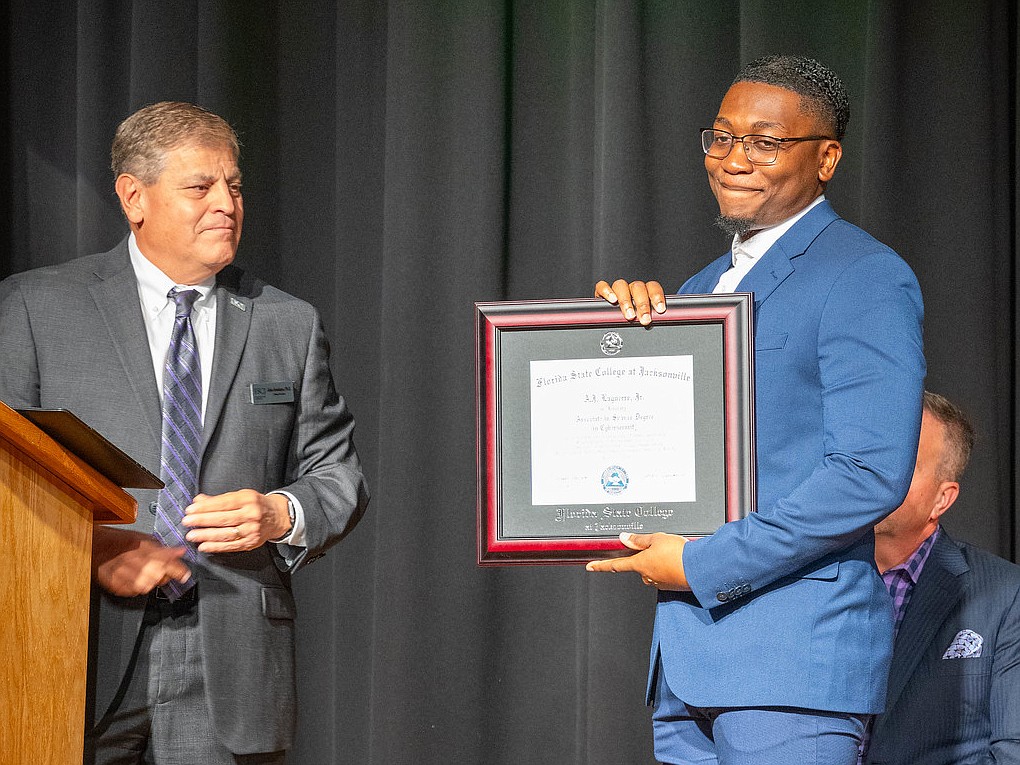 Florida State College at Jacksonville President John Avendano presented a posthumous degree to A.J. Laguerre Jr., accepted by his brother, Quantavious Laguerre.