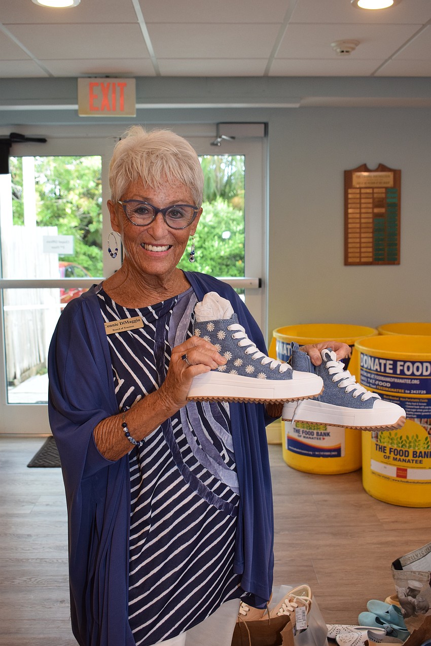 Connie DiMaggio shows shoe donations the Chapel is donating to Turning Points.