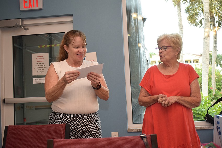 Carolyn Nielsen receiving $5,000 for Turning Points from Jamie Engel and the Longboat Island Chapel.