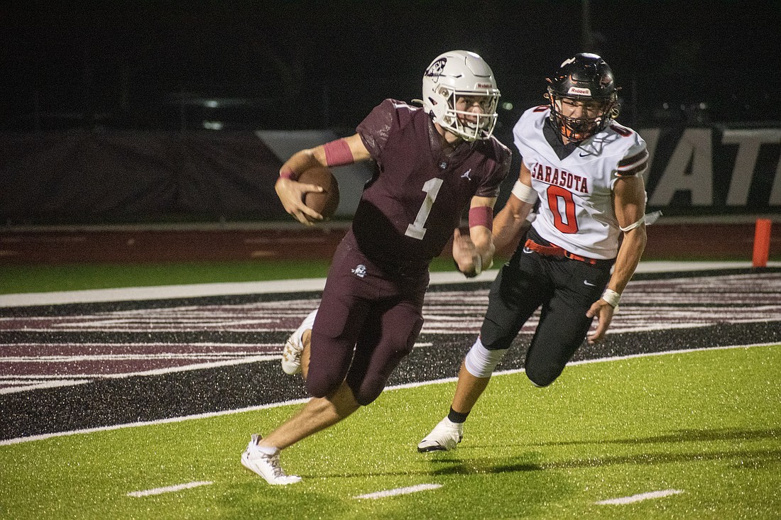 Braden River senior quarterback Lucas Despot (1) escapes the pocket on a scramble.