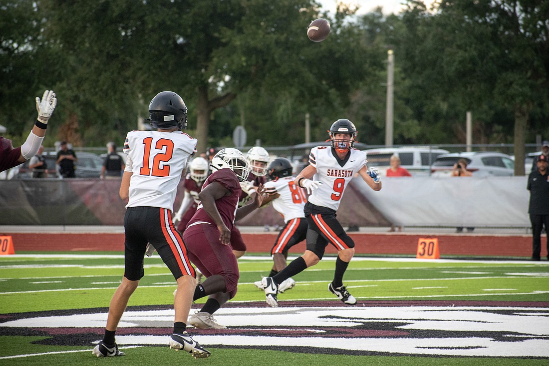 Sarasota High freshman quarterback Hudson West throws a pass to junior Scotty Wells.