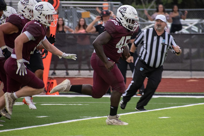 Braden River High sophomore Freedom McDaniel races to the end zone after picking up a Sarasota High fumble.