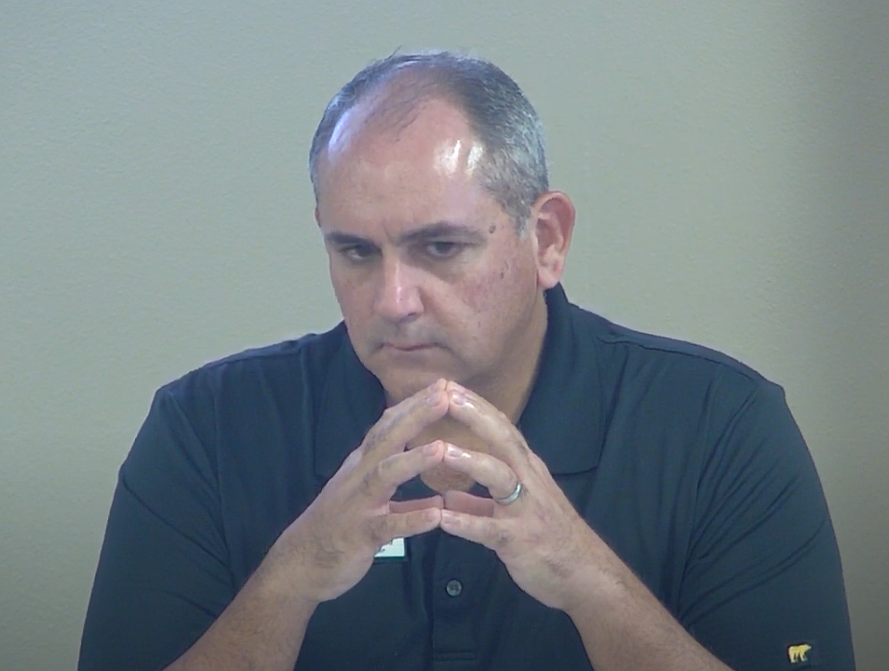 Flagler County School Board Chair Will Furry listens to Chief Financial Officer Patty Wormeck's Sept. 3 report on last year's cyber theft. Image from Flagler Schools video