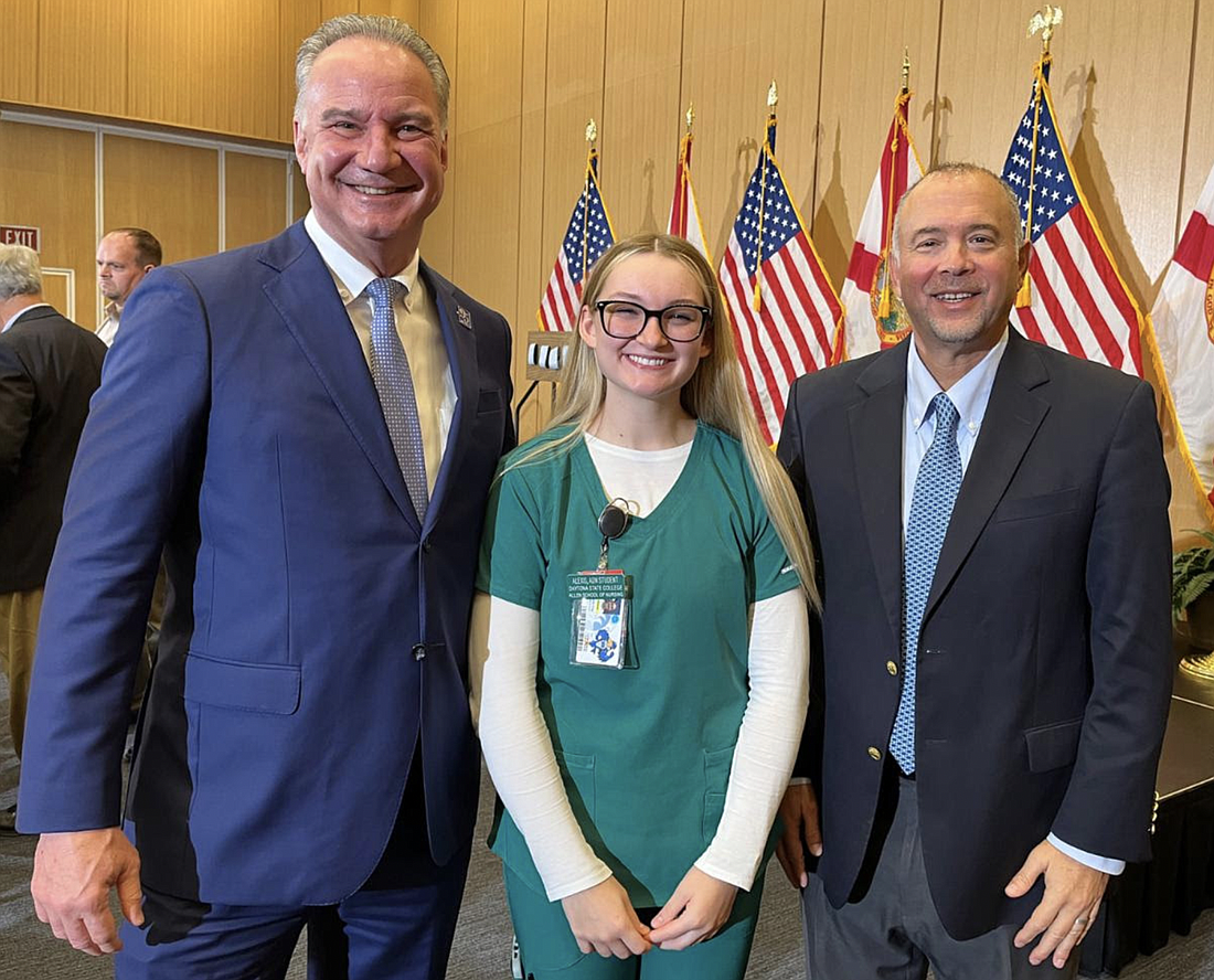 Second year Nursing student and Halifax Health monitor tech Alexis Marie Shay with Daytona State College President Dr. Tom LoBasso (right) and Halifax Health President and CEO Jeff Feasel. Courtesy of Daytona State College