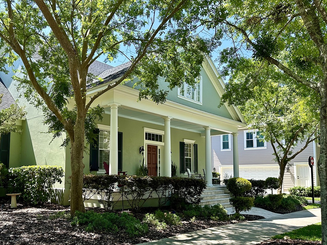 Front yard elm trees and a live oak street tree frame the classical architecture of a home on Anson Lane.