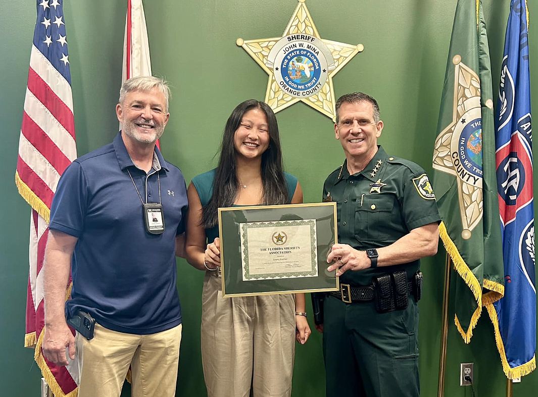 Orange County Sheriff John Mina, right, presented the Florida Sheriffs Association STEM Scholarship award to Emma Koehler, daughter of Joe Koehler, fugitive sergeant with the Orange County Sheriff’s Office.