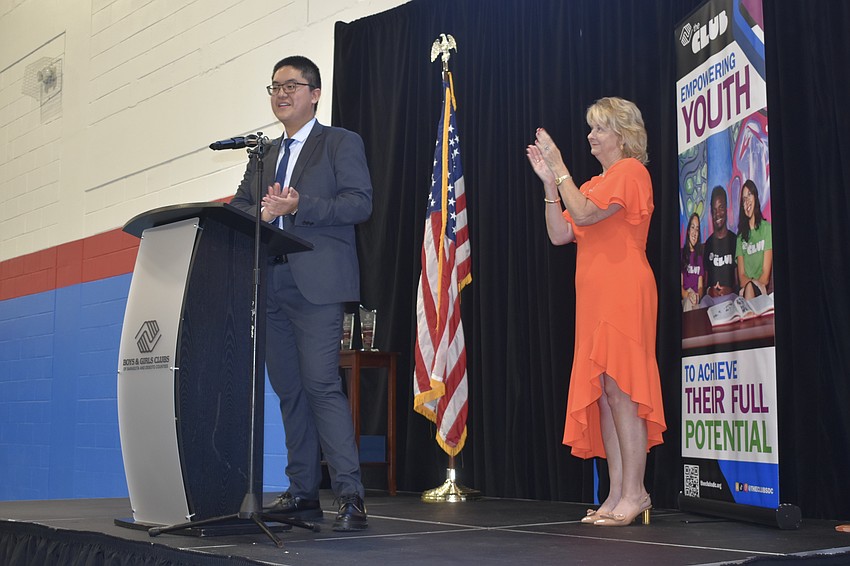 Alvin L., a junior at Florida Virtual High School, is applauded by former Senator Lisa Carlton as he gives a speech.