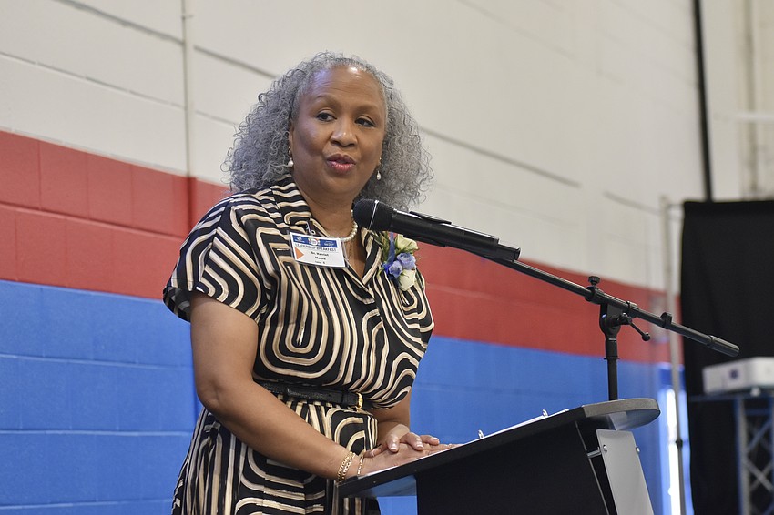 Harriet Moore, director of Strategic Engagement at Sarasota County Schools, offers a speech.