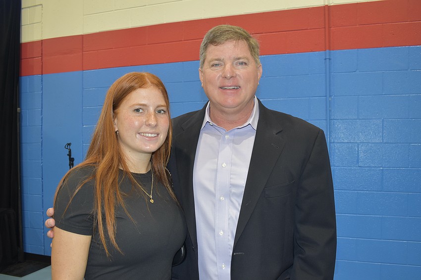 Meghan Cox, 17, attends the ceremony with her father, Halfacre President and owner Jack Cox, who was being honored for his contributions to the community's youth.