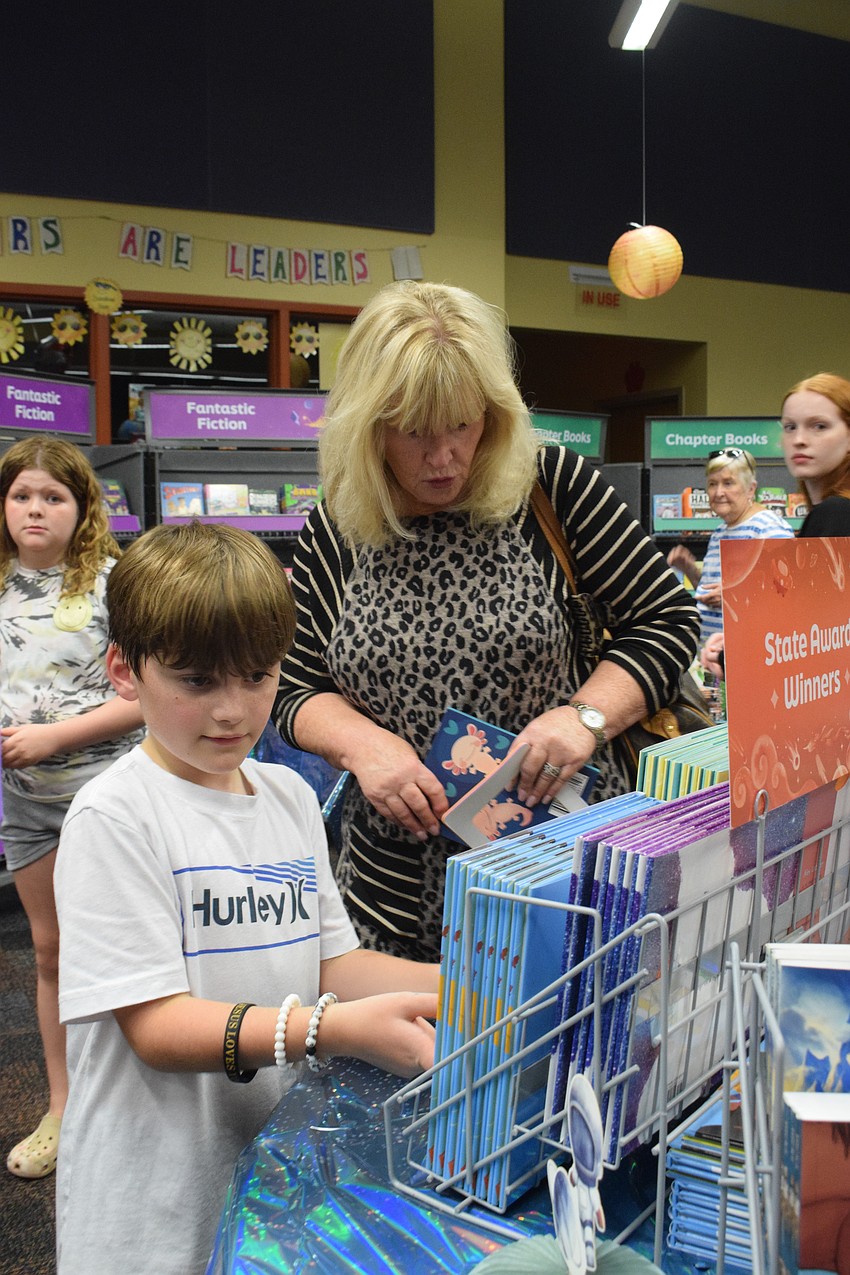 Third grader Sean Ruffing and his grandmother Linda Maughan browse the book fair. 