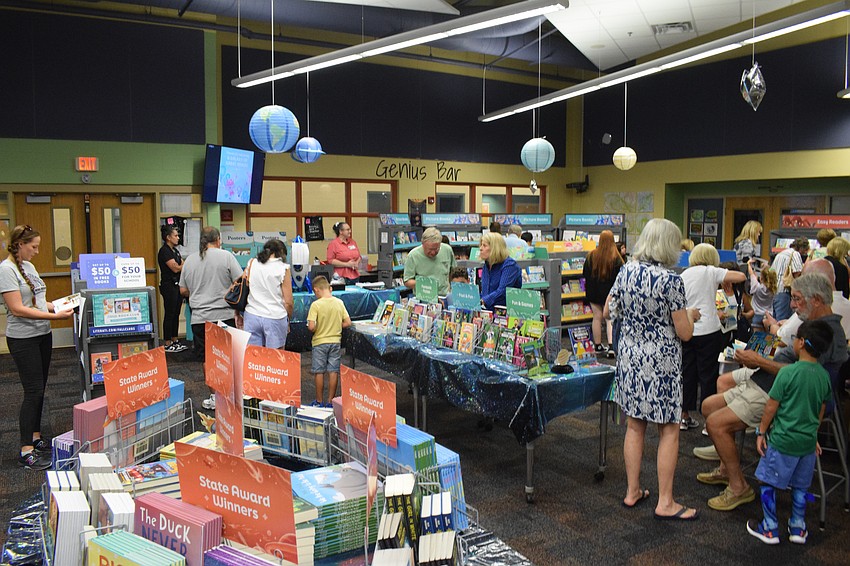The book fair is abuzz as students and their grandparents shop for their next favorite reads.