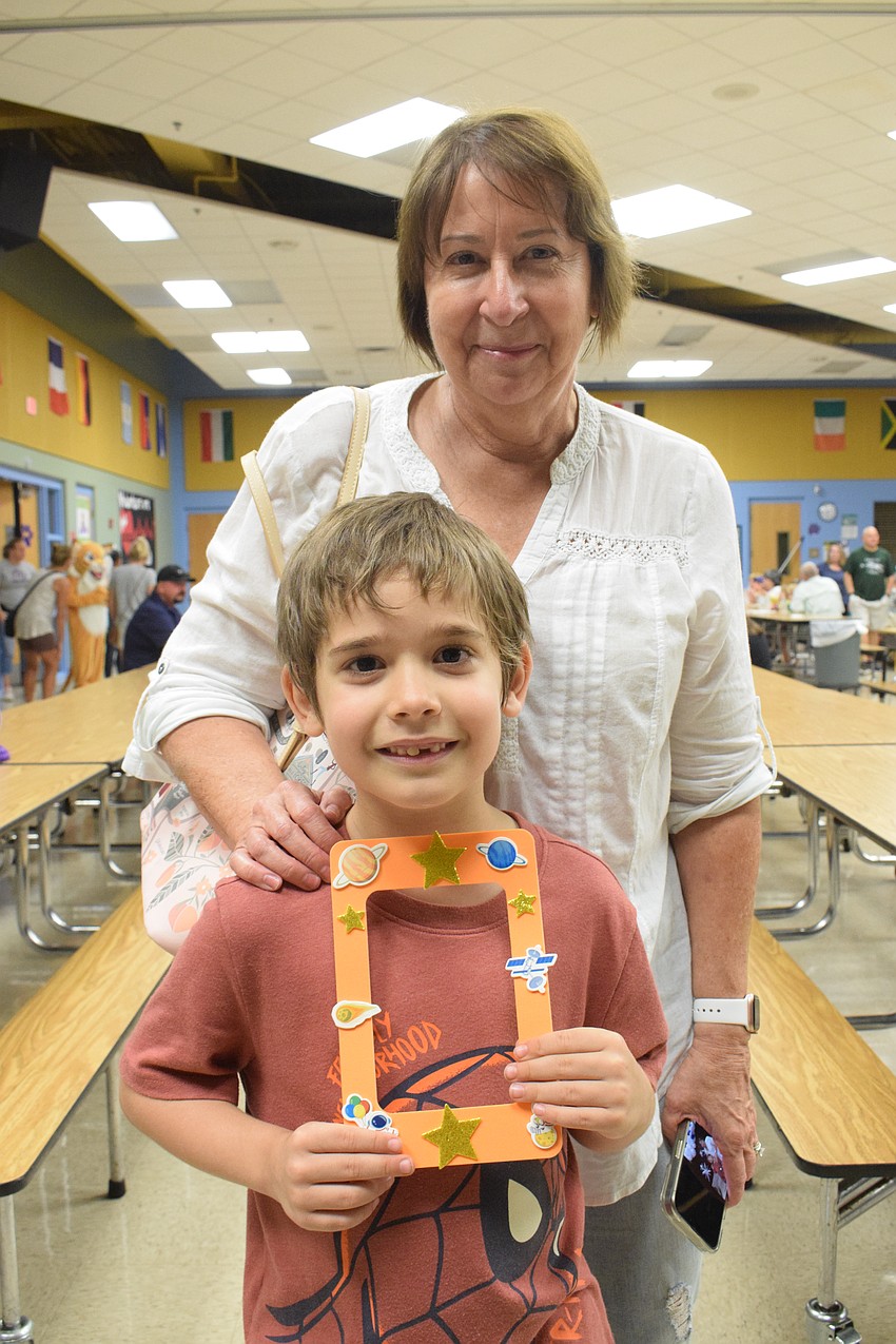 Kate Knapp and her grandson Michael Knapp, a first grader, show off the frame they made. Michael Knapp says it's fantastic spending time with his grandmother.