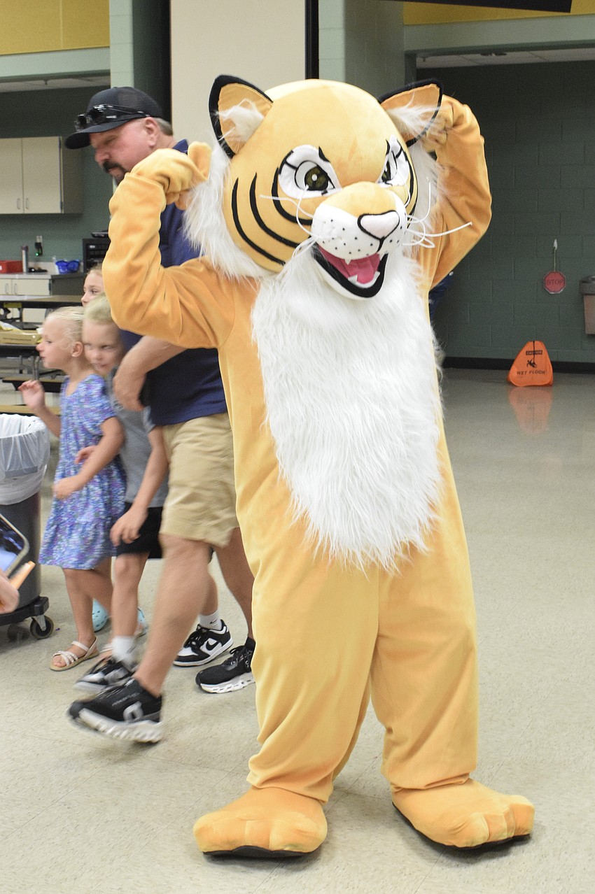 Gilbert W. McNeal Elementary School's mascot is ready to celebrate Grandparents Night with students and their grandparents. He takes photos with them, dances and gives them fist bumps and high fives.
