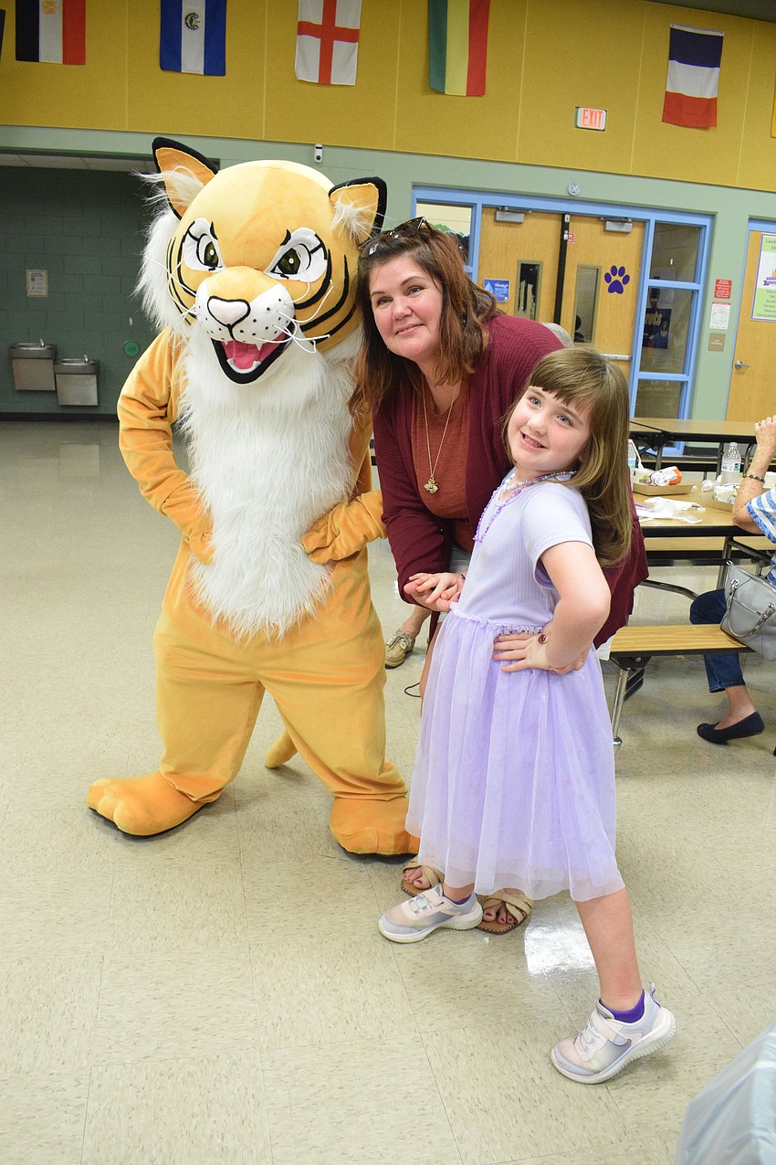 Gilbert W. McNeal Elementary School's mascot meets Jessica Williams and her granddaughter Eleanor Rea, a kindergartner.