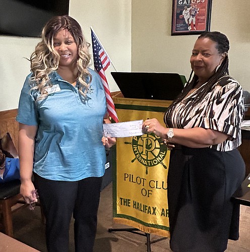 Elissa Thomas, PCHA vice president, presents donation to Janet Bryant, executive director of The Rose Marie Bryon Children's Center. Courtesy photo