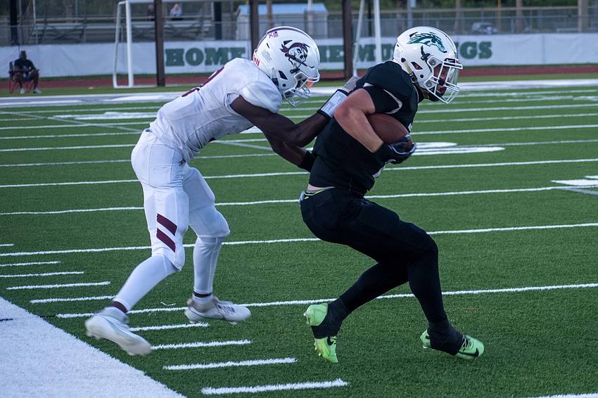Braden River senior Jaron Fields corrals Lakewood Ranch junior Viktor Monoki on the sideline. Fields was penalized for a horse-collar tackle on the play.