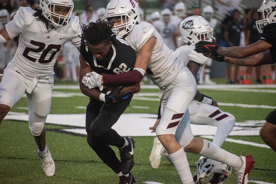 Lakewood Ranch junior Tommy Bowdre fights through Braden River tackles after losing his helmet.