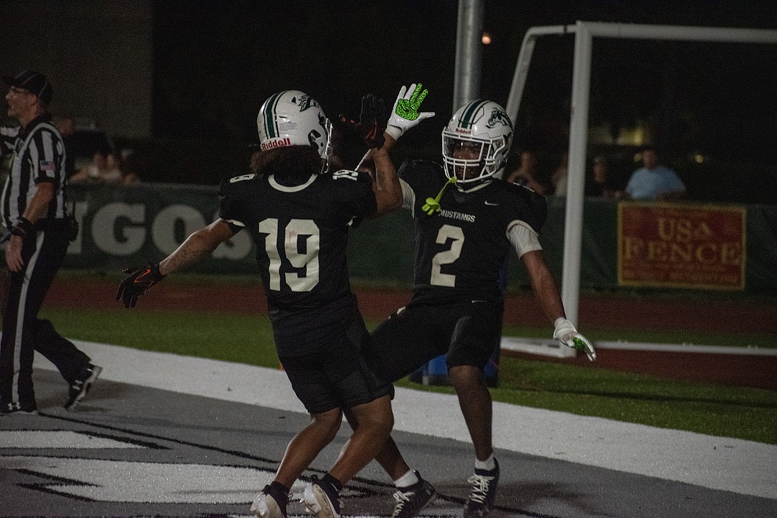 Lakewood Ranch seniors Jamarrion Roden (19) and Cullen McRae II (2) celebrate after McRae's second touchdown of the game against Braden River.