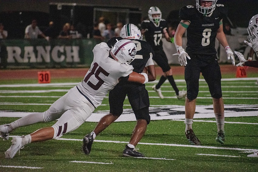 Braden River senior linebacker Aidan Rivera (15) drags down Lakewood Ranch senior running back Cullen McRae II.