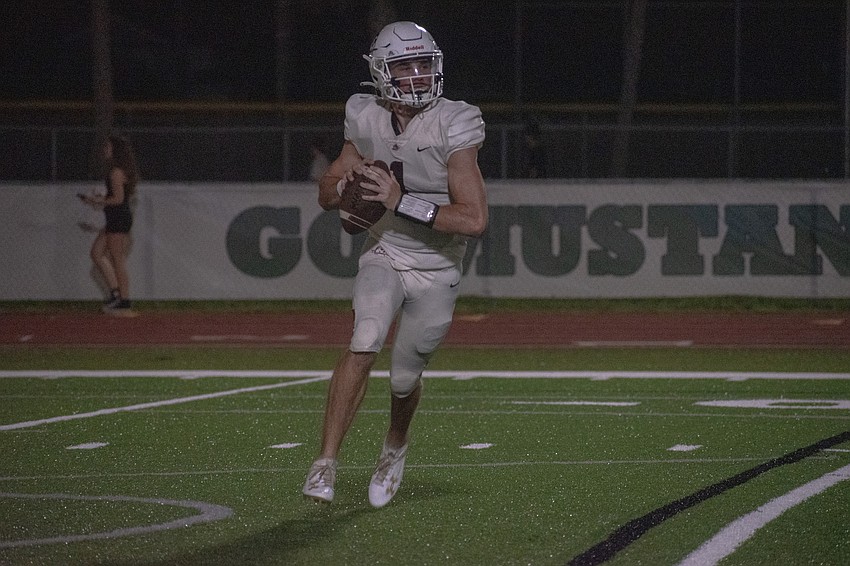 Braden River senior quarterback Lucas Despot rolls to his right to find an open wide receiver.