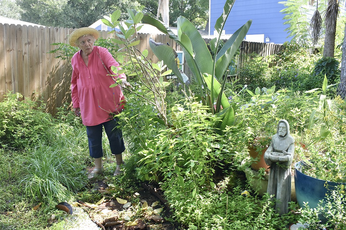 Lucy Tobias walks in her garden.