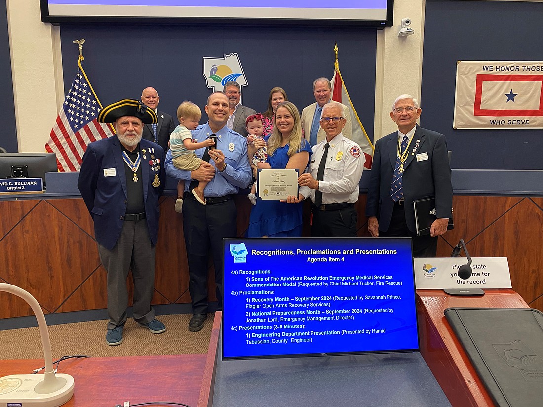 Firefighter paramedic Andrew Shook receiving his award from the Sons of the American Revolution. Courtesy of the Flagler County Commission
